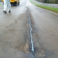 Filled crack in asphalt on a main road with the best pothole patch kit- Degafill-- MMA flooring manufacturers